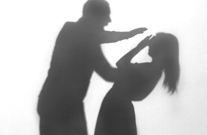Silhouette of man hurting a woman